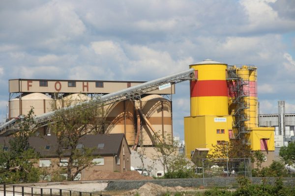 Photo by Carsten Bleek yellow and red building near trees during daytime