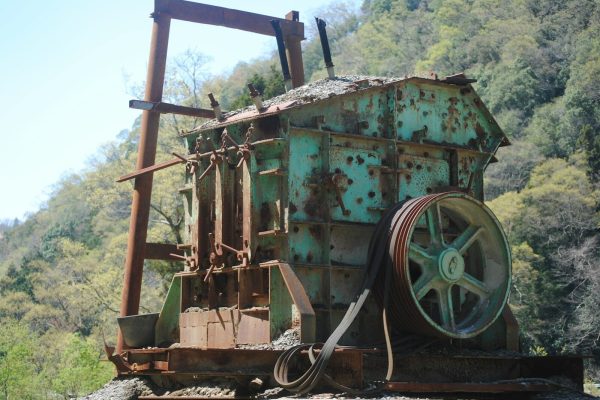Photo by t Penguin Old rusty industrial machinery in a forest clearing