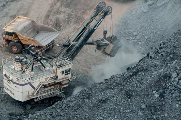 Photo by Fabio Lima a dump truck is dumping gravel into a pile